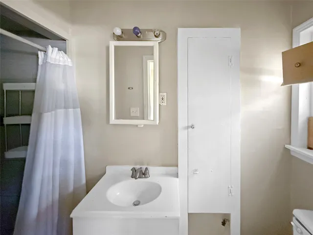 a bathroom with a sink toilet and tub