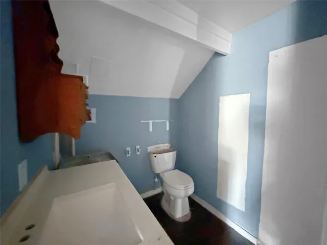 a white toilet sitting next to a bathroom sink