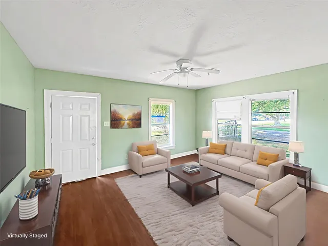 a living room with furniture and wooden floor