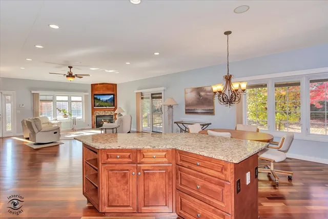 a kitchen with stainless steel appliances granite countertop a stove a sink and a wooden cabinets