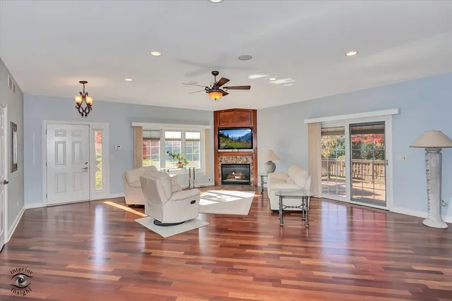a living room with fireplace furniture and a wooden floor