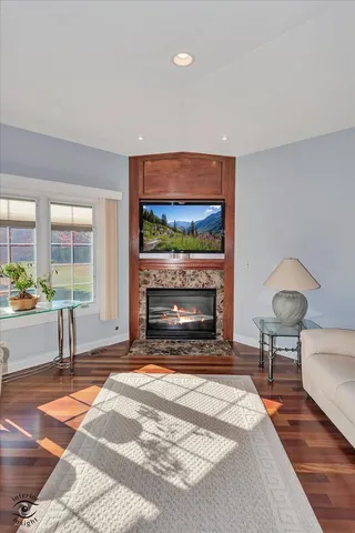 a living room with furniture a flat screen tv and a fireplace