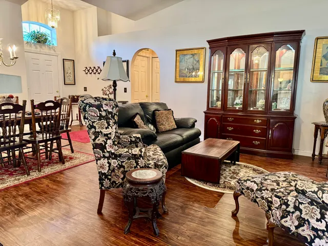 a bedroom with furniture and wooden floor
