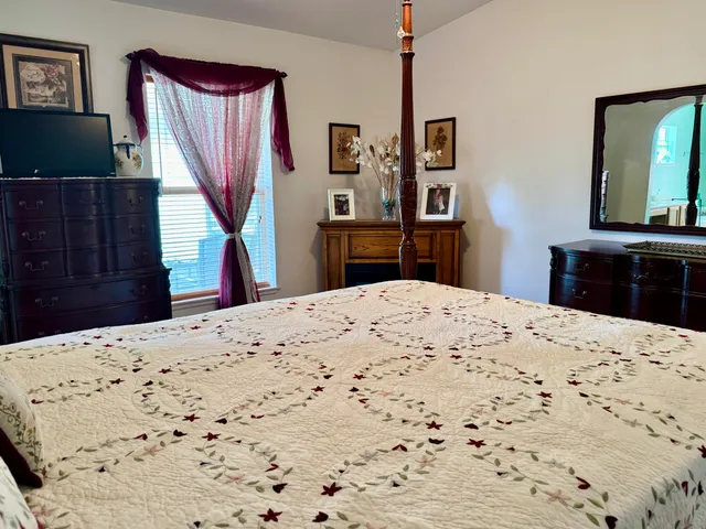 a bedroom with a bed and a fireplace