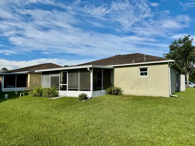 a view of a dining room with furniture a rug and wooden floor