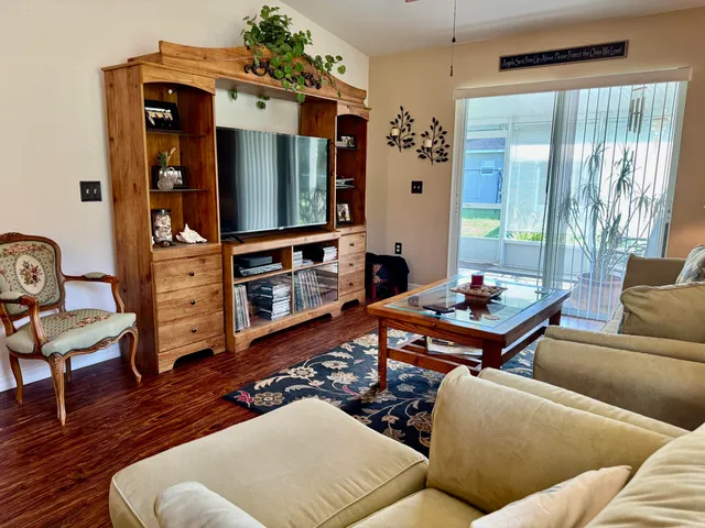 a living room with furniture a rug and a window