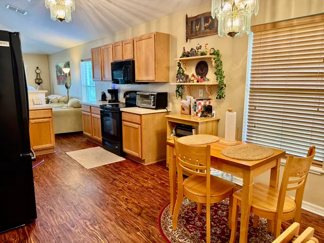 a living room with furniture a window and a flat screen tv