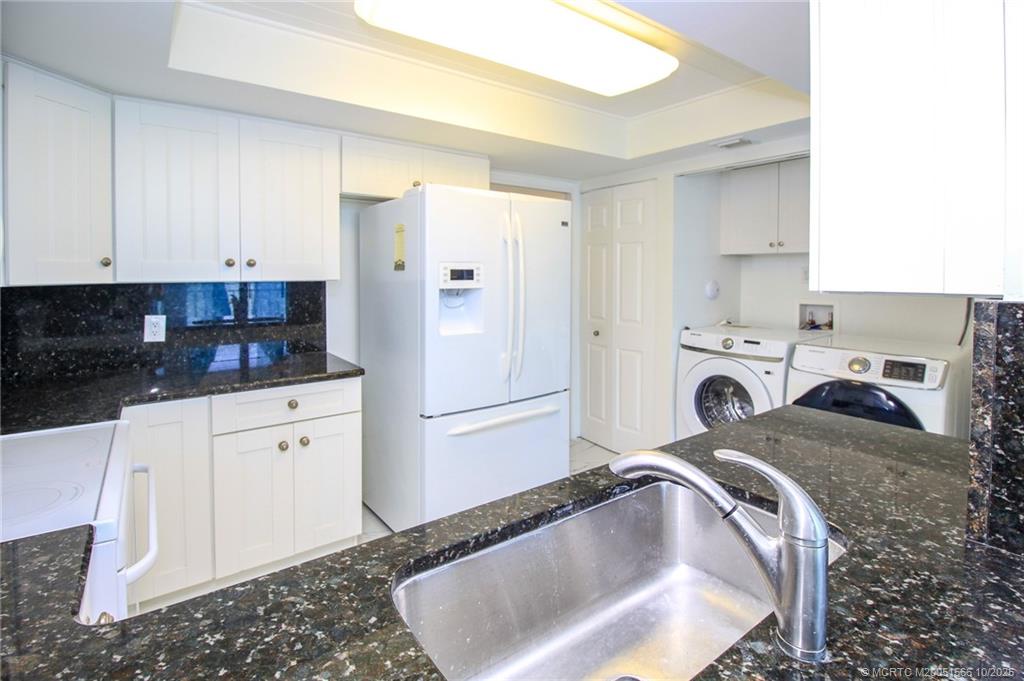 8750 South Ocean Drive, Unit 1635 Jensen Beach, FL 34957 - Photo 7 of 36 a kitchen with a refrigerator a stove a sink and cabinets