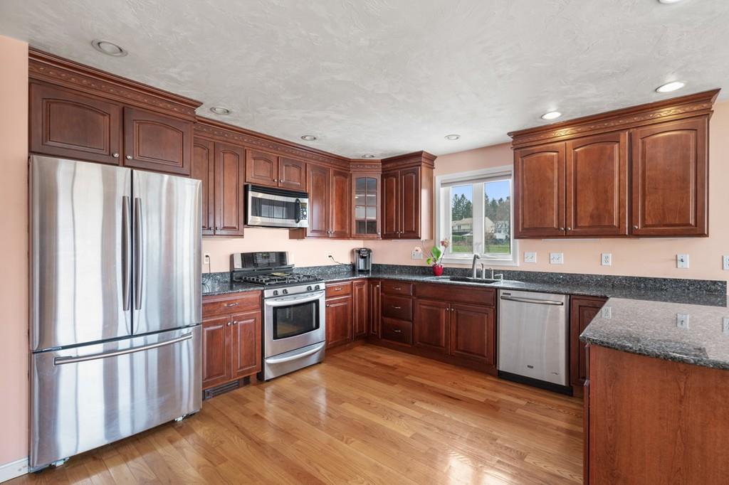 13 Uptack Road Groveland, MA 01834 - Photo 13 of 42 a kitchen with stainless steel appliances granite countertop a refrigerator stove top oven and sink