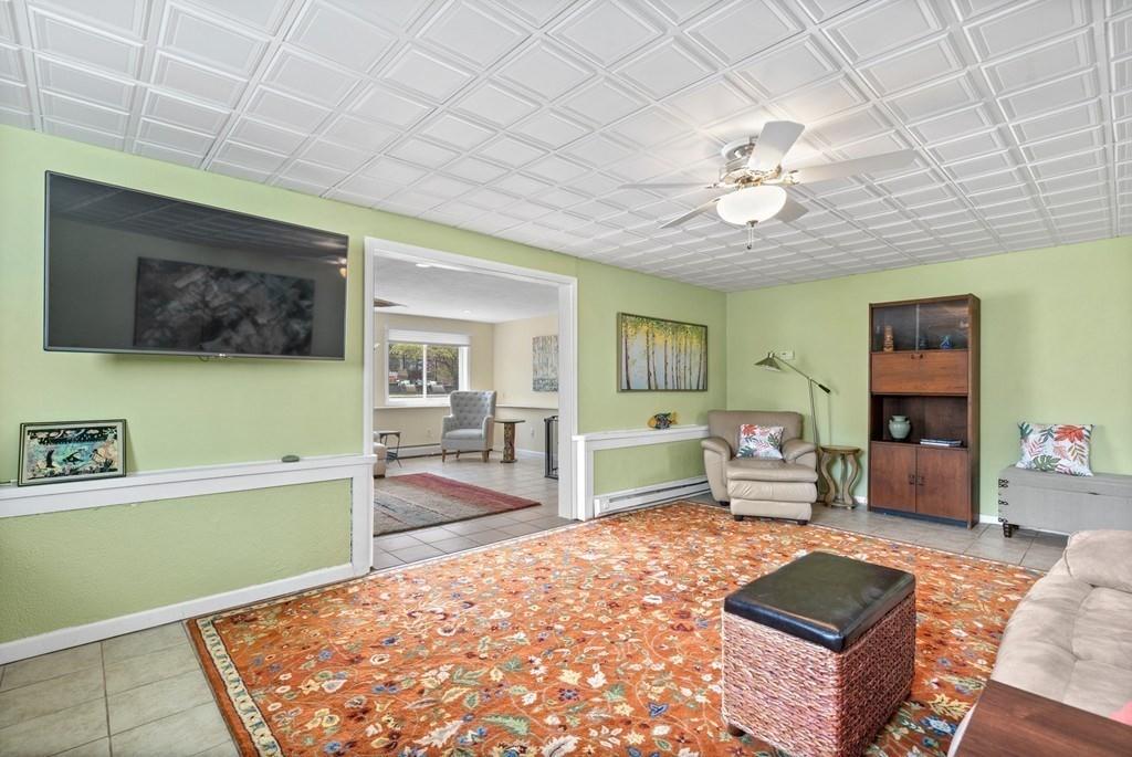 13 Uptack Road Groveland, MA 01834 - Photo 26 of 42 a living room with furniture and a flat screen tv