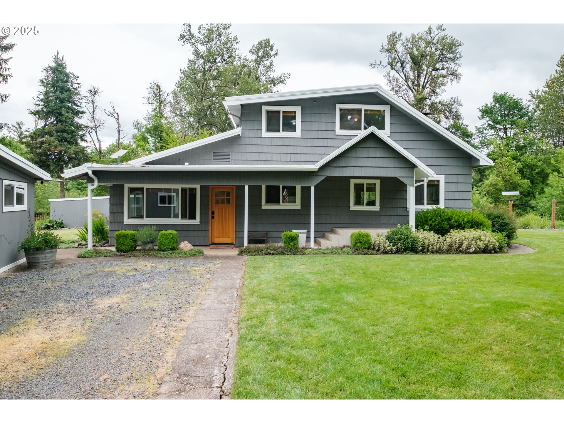 a front view of a house with a garden