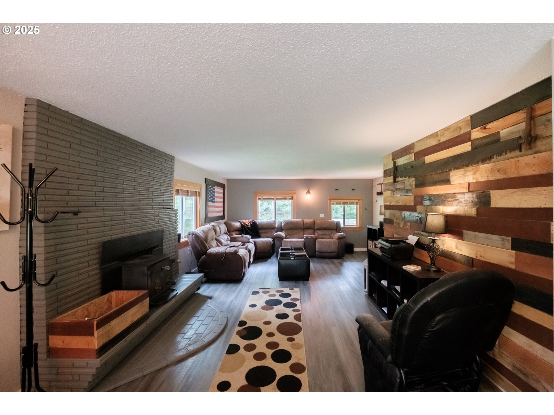 40325 Upper Calapooia Drive Sweet Home, OR 97386 - Photo 13 of 42 a living room with furniture a fireplace and a flat screen tv