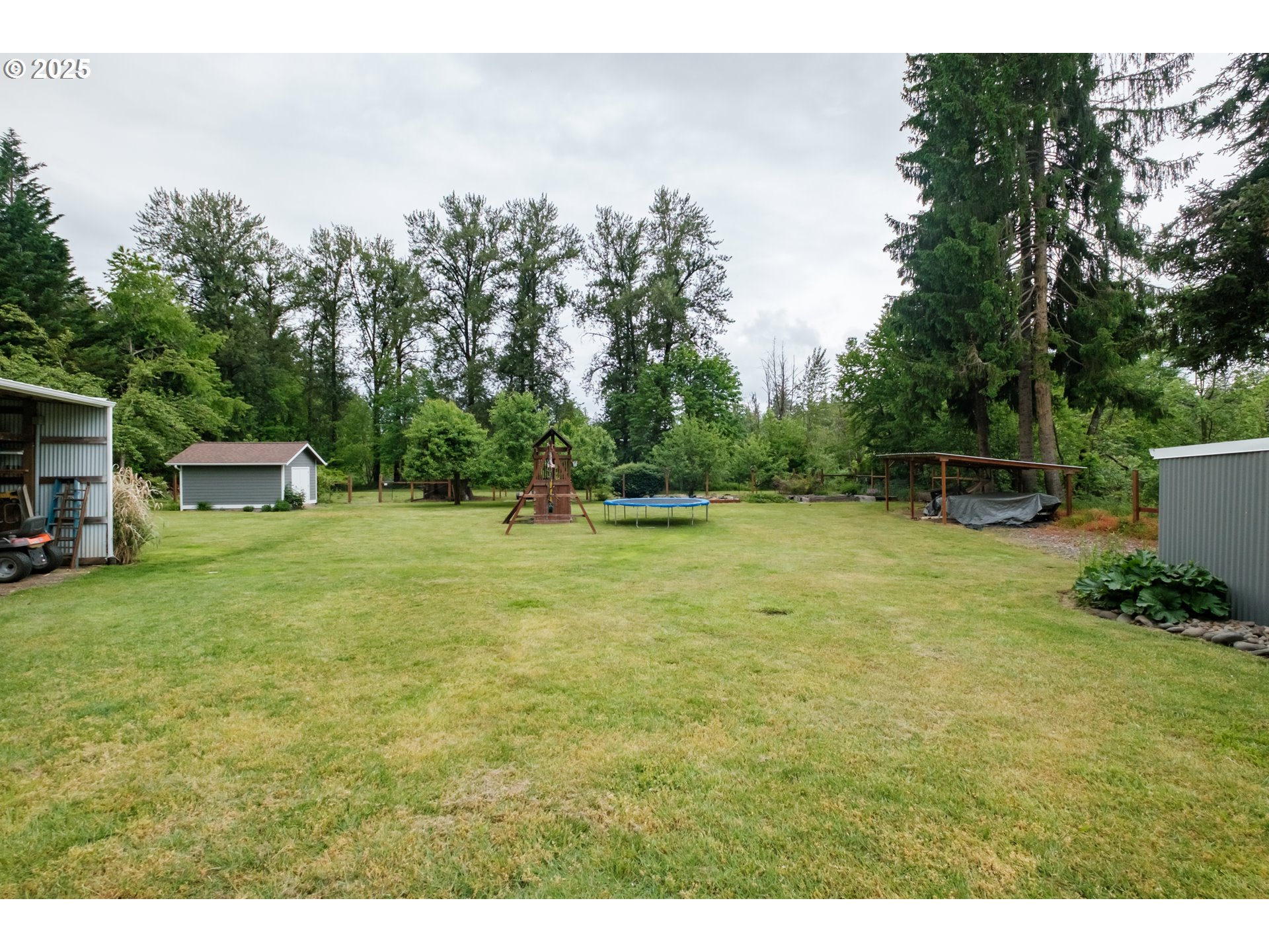 40325 Upper Calapooia Drive Sweet Home, OR 97386 - Photo 32 of 42 a backyard of a house with table and chairs