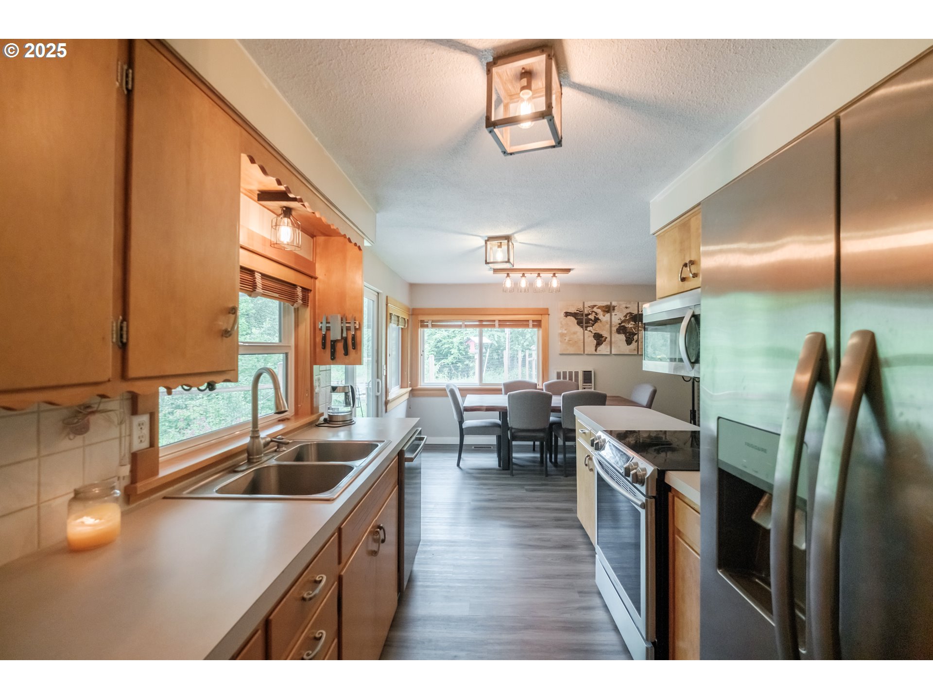 40325 Upper Calapooia Drive Sweet Home, OR 97386 - Photo 9 of 42 a kitchen with stainless steel appliances a sink a counter top space and living room view