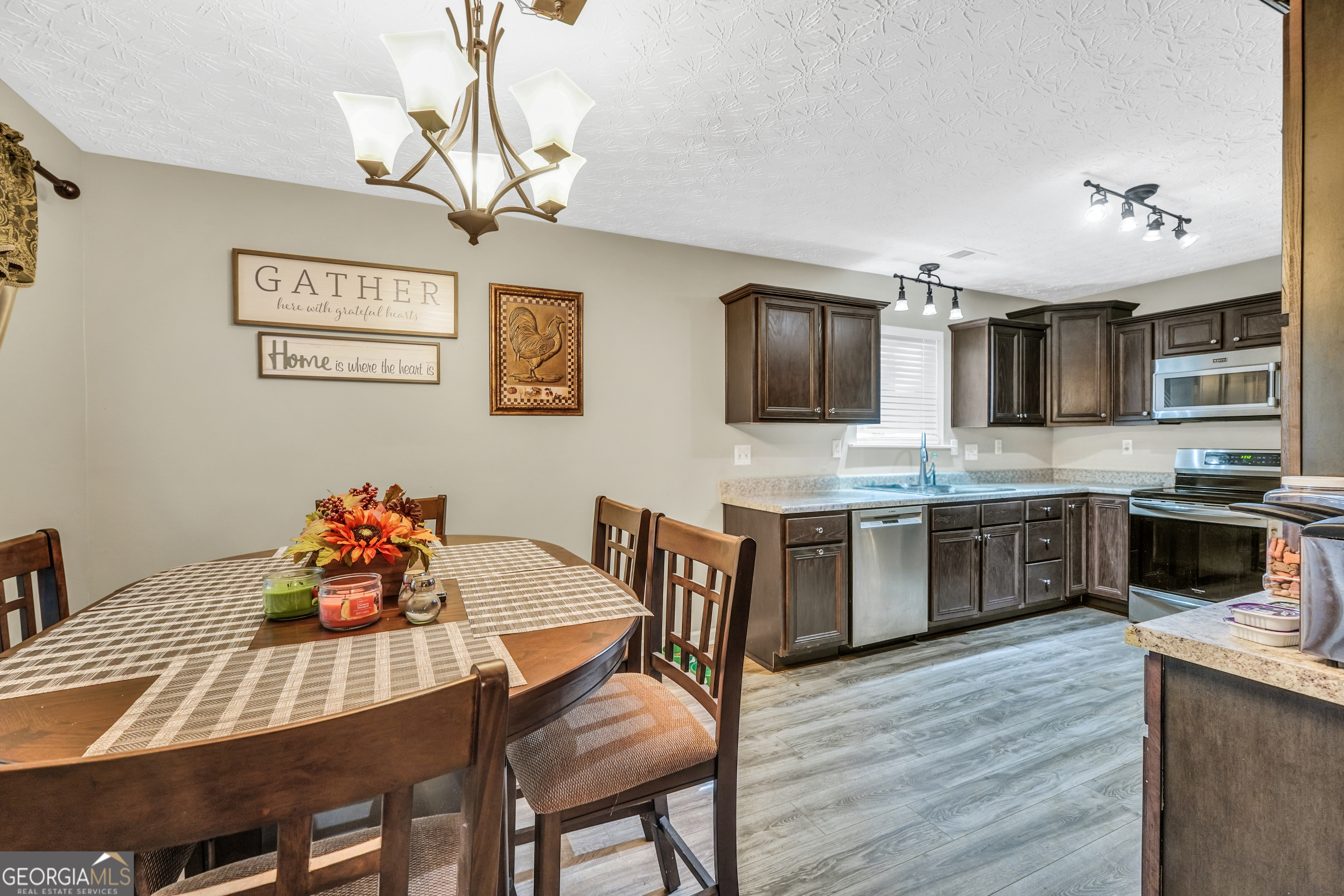 610 Kyle Court Locust Grove, GA 30248 - Photo 15 of 35 a kitchen with a dining table and chairs