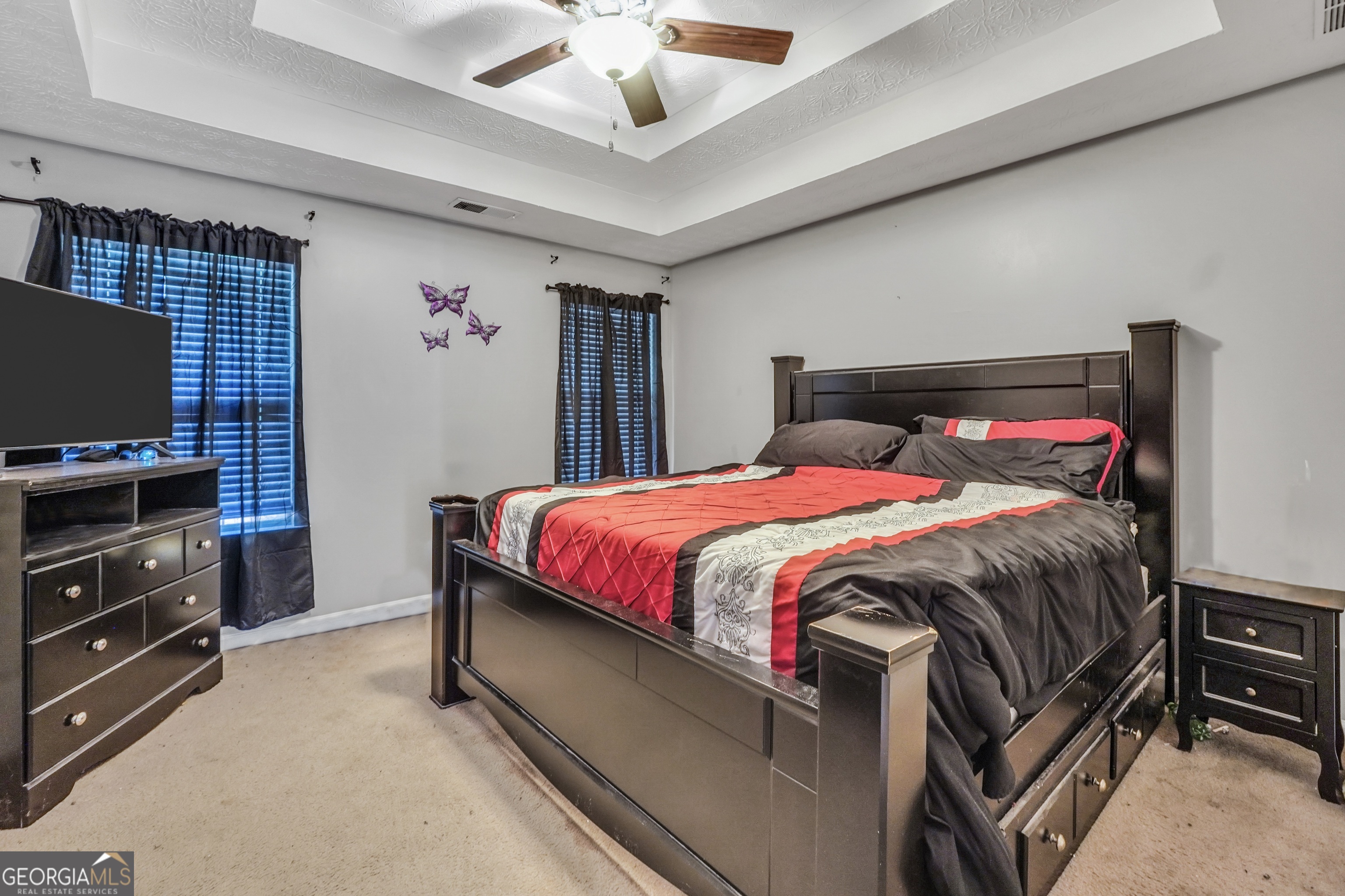 610 Kyle Court Locust Grove, GA 30248 - Photo 16 of 35 a bedroom with a bed and a flat screen tv