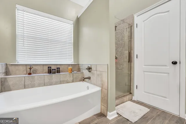 a bathroom with a bathtub and a shower
