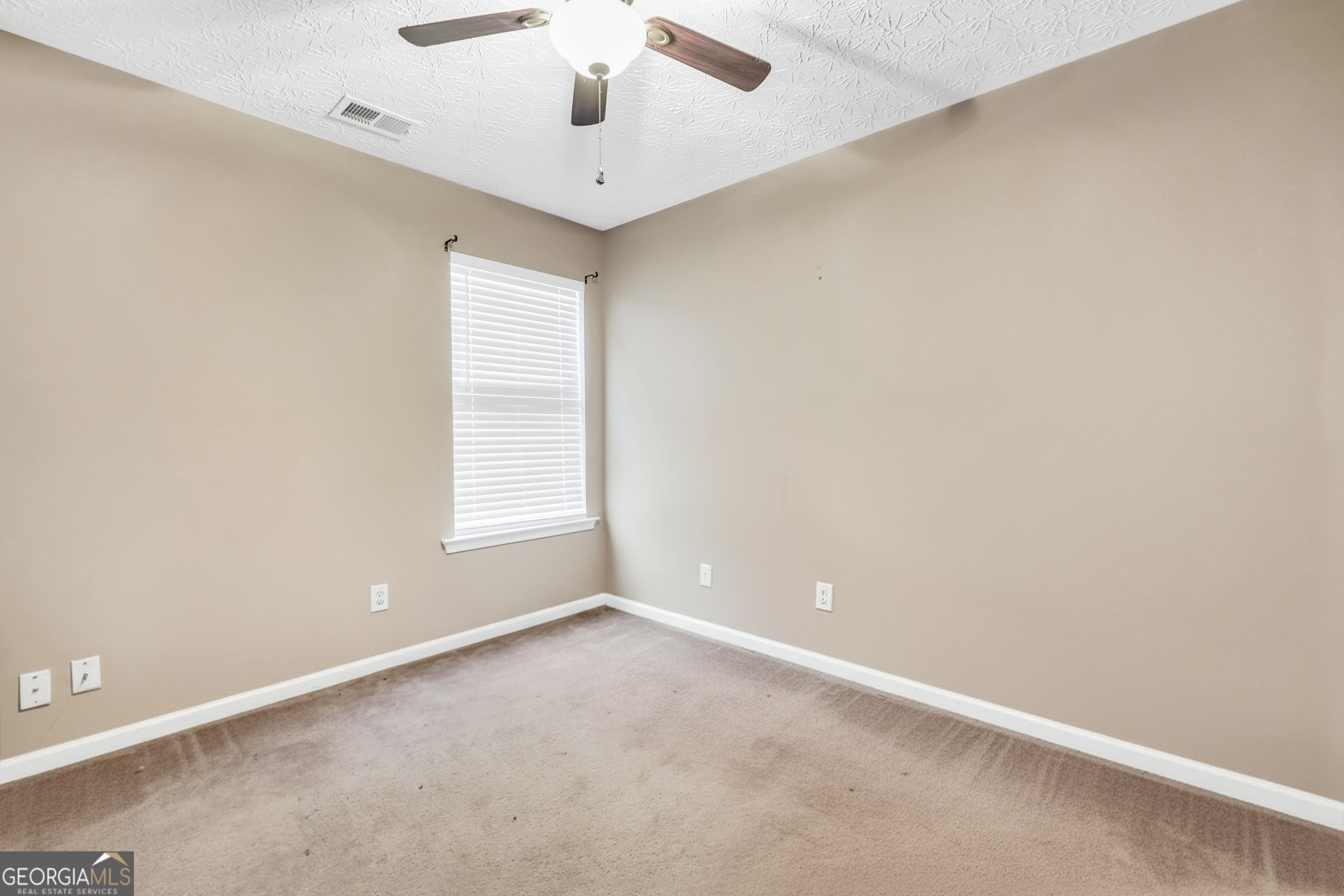 610 Kyle Court Locust Grove, GA 30248 - Photo 26 of 35 an empty room with a window and a ceiling fan