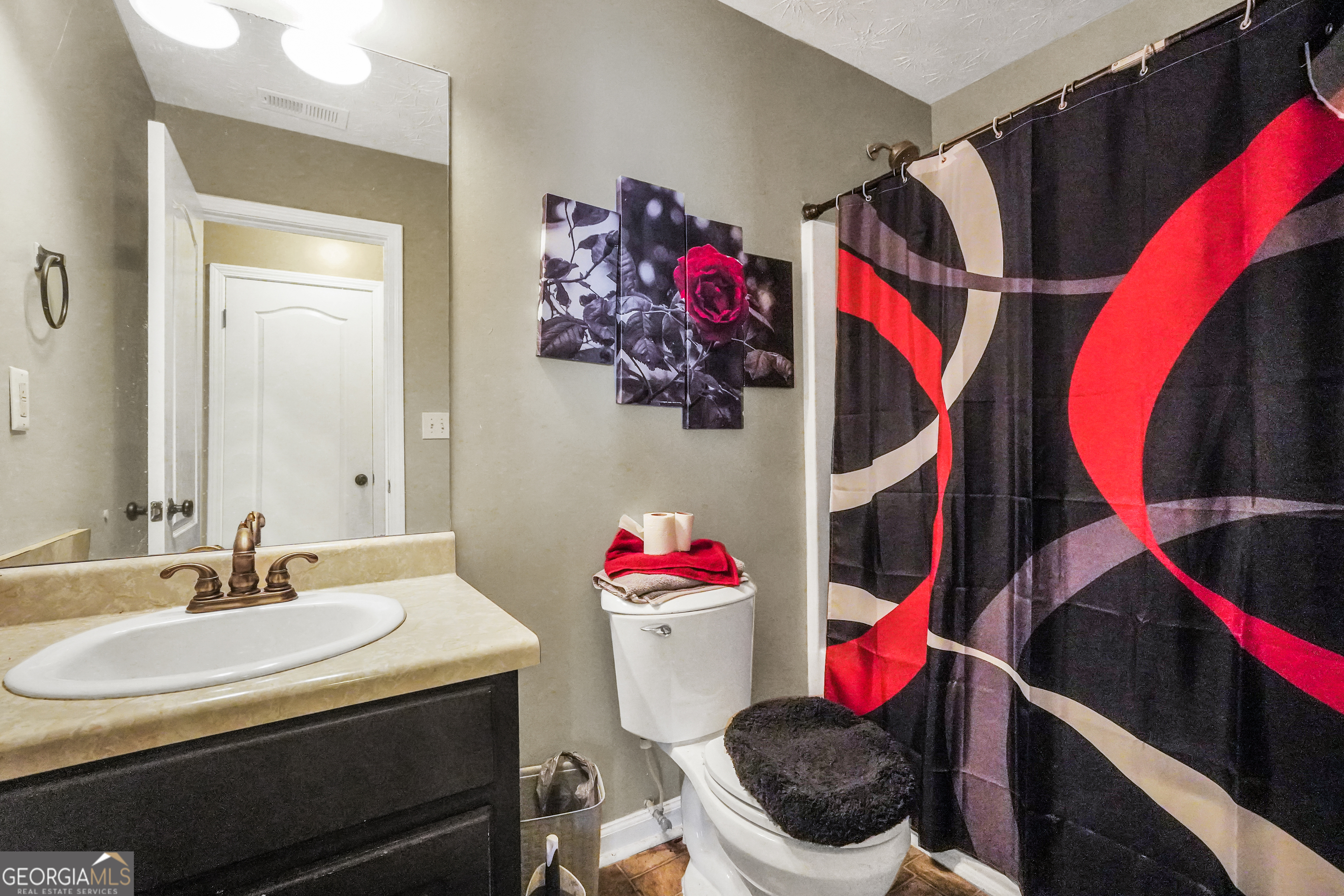 610 Kyle Court Locust Grove, GA 30248 - Photo 27 of 35 a bathroom with a sink and a mirror