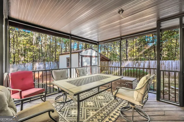 a balcony with furniture and wooden floor