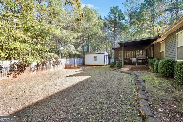 a view of a house with a yard and tree