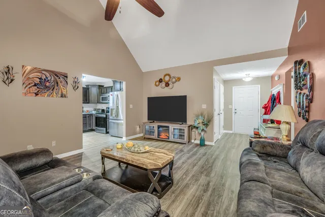 a living room with furniture and a flat screen tv