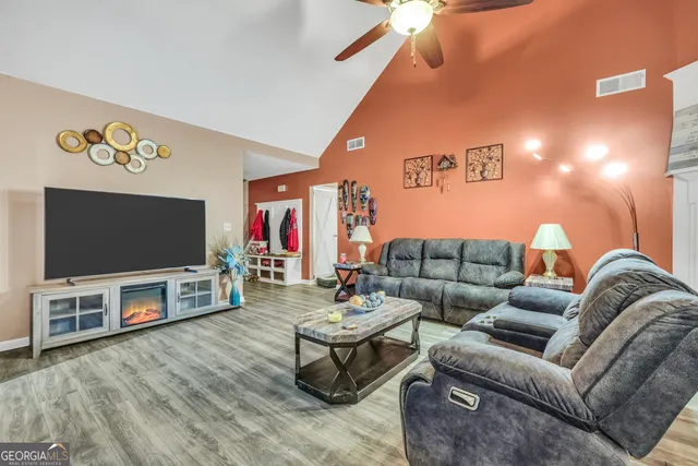 a living room with furniture and a flat screen tv