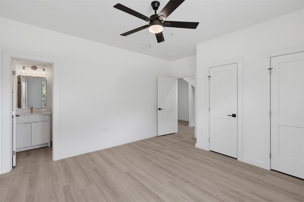 516 South O Connor Road Irving, TX 75060 - Photo 6 of 23 Spacious room featuring wood-finish flooring and a contemporary ceiling fan