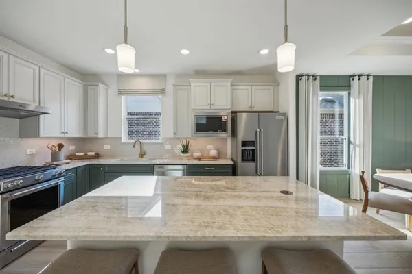 a kitchen with a sink stove and microwave
