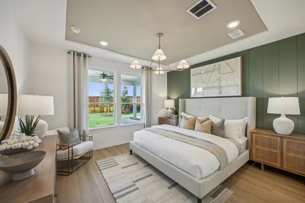 a bedroom with bed and a chandelier