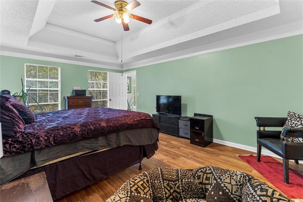 3234 Mineral Ridge Lane Stone Mountain, GA 30087 - Photo 27 of 55 a bedroom with a bed and wooden floor