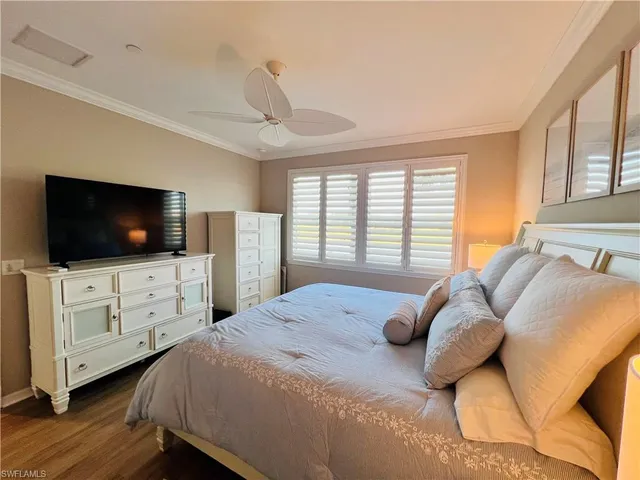 a bedroom with a large bed and a flat screen tv