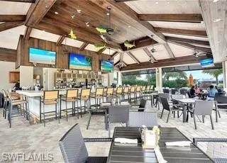 a outdoor space with lots of tables a chairs and chandelier