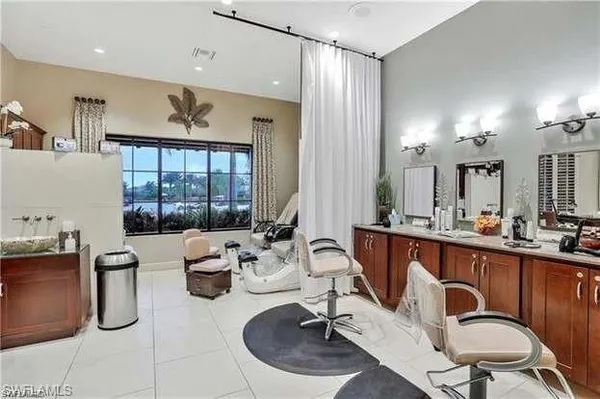 a kitchen with sink refrigerator dining table and chairs