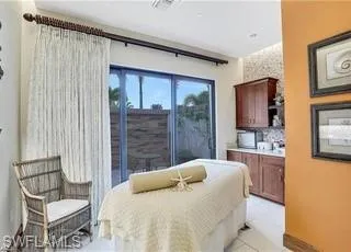 a bedroom with a bed and a chair