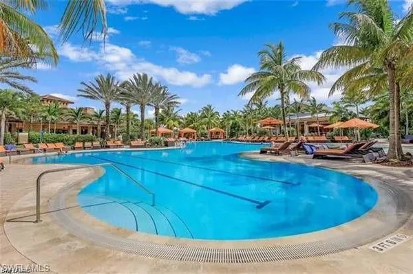 a swimming pool with outdoor seating and yard