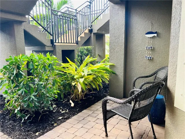 a view of a house with backyard and sitting area