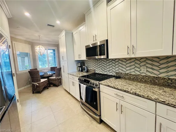 a kitchen with a stove a sink and a microwave