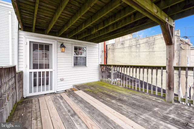 a view of a house with wooden fence