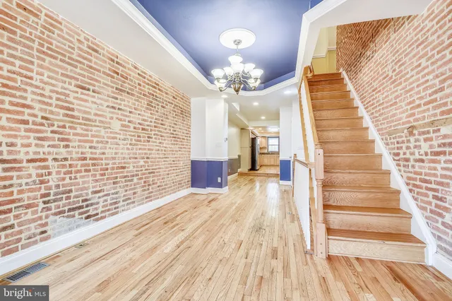 a view of a room with wooden floor and staircase