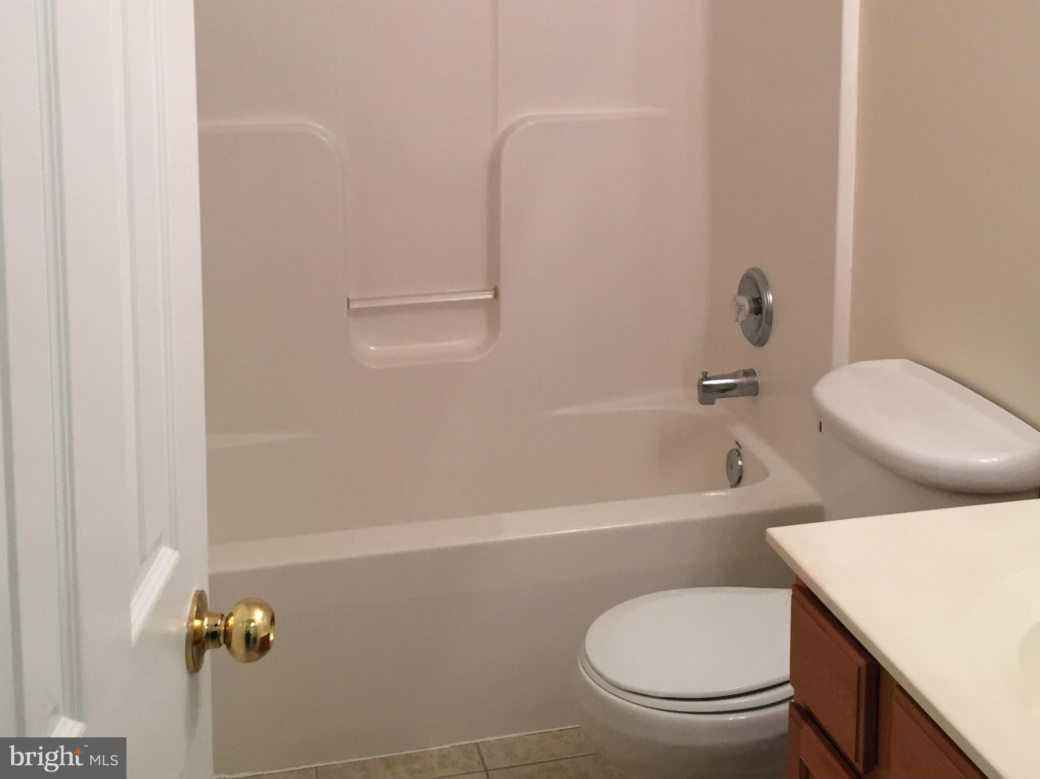 41 Gibson Road Inwood, WV 25428 - Photo 11 of 26 a bathroom with a toilet and a bathtub