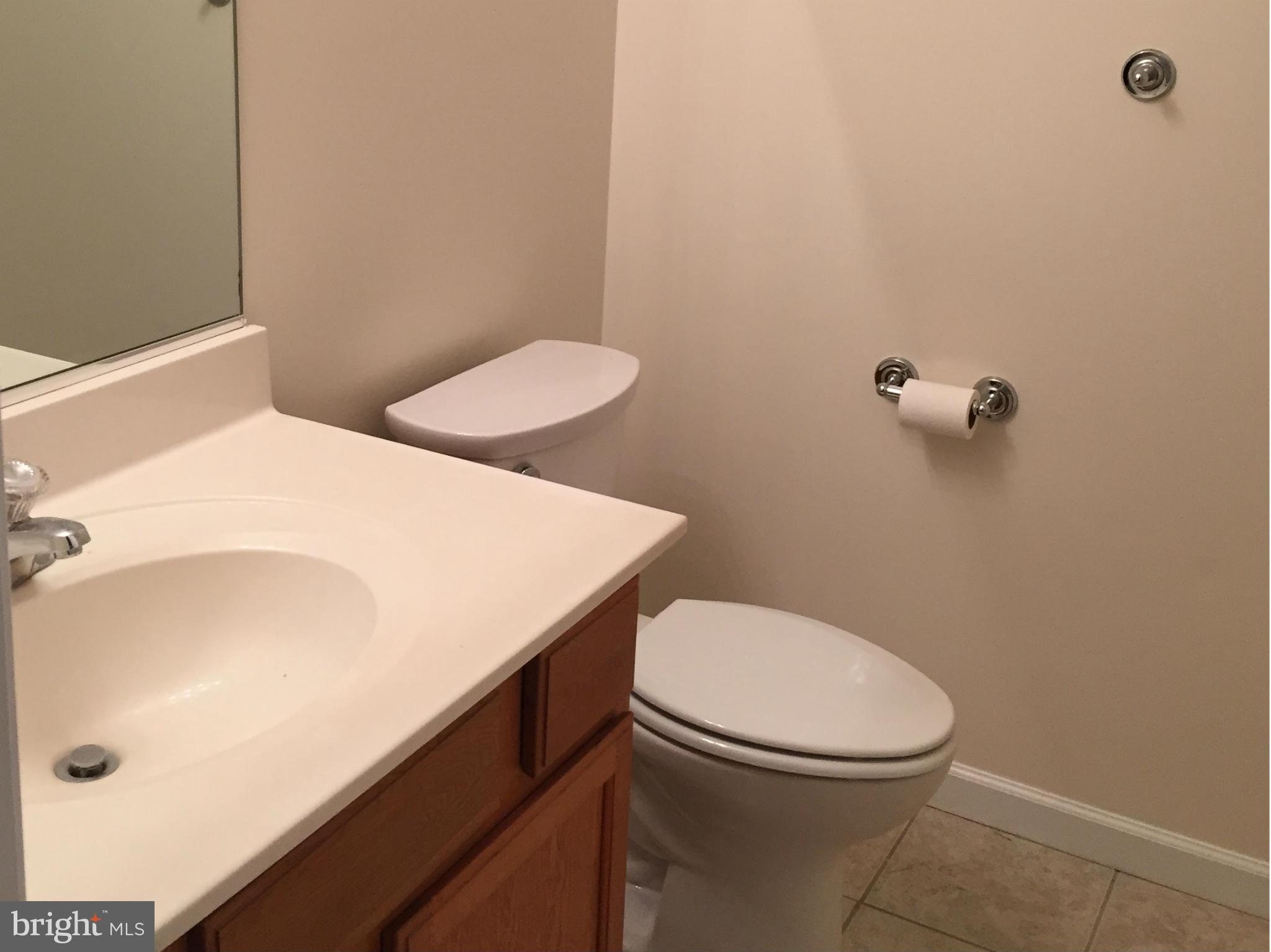 41 Gibson Road Inwood, WV 25428 - Photo 23 of 26 a white toilet sitting next to a bathroom sink
