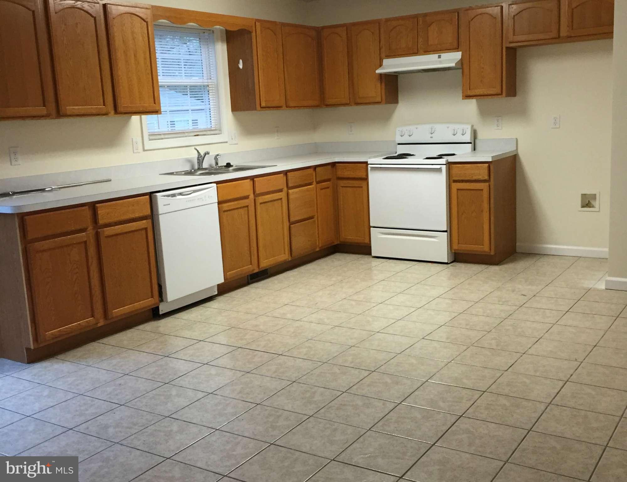 41 Gibson Road Inwood, WV 25428 - Photo 4 of 26 a kitchen with a stove top oven sink and cabinets