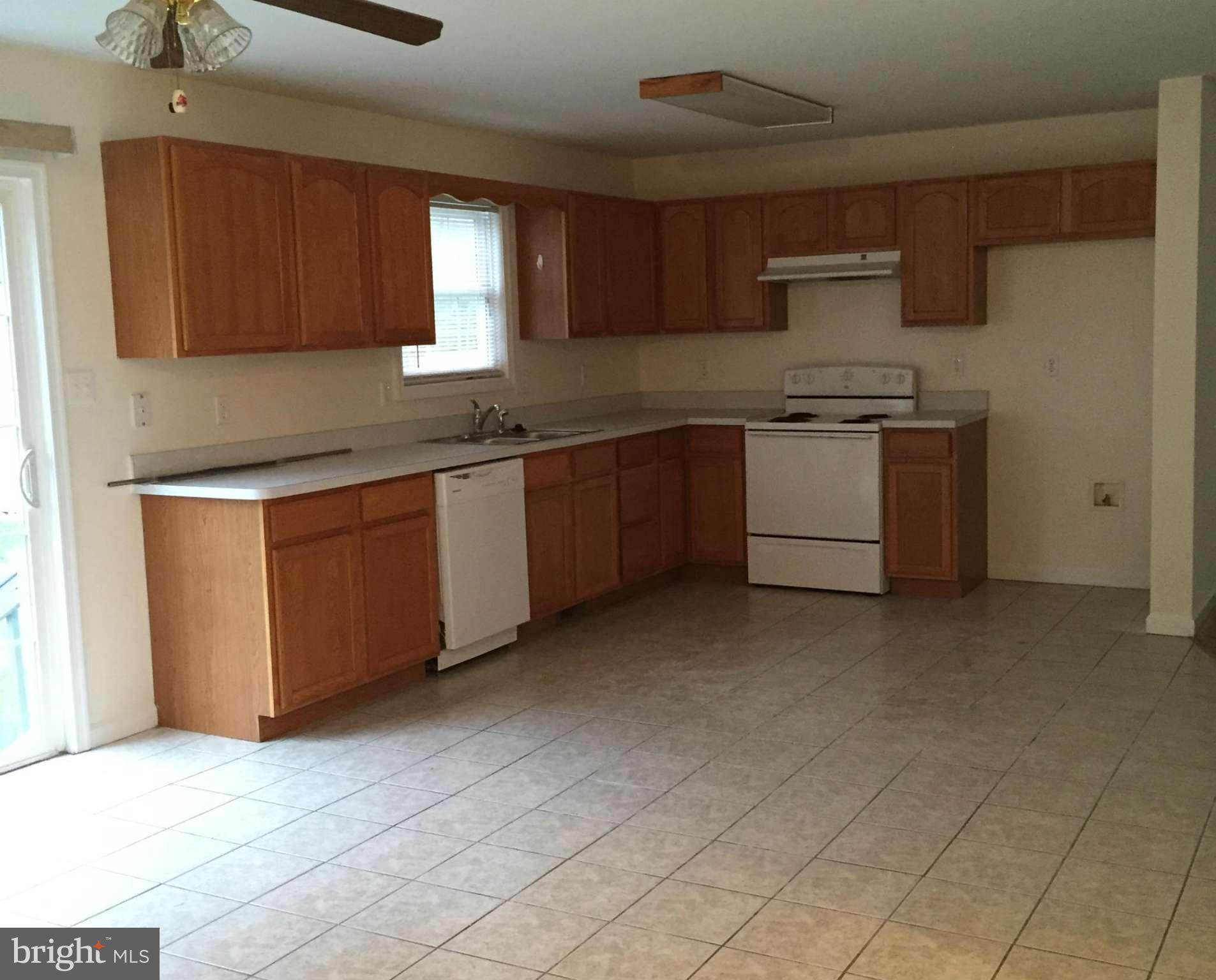 41 Gibson Road Inwood, WV 25428 - Photo 6 of 26 a kitchen with granite countertop a sink a counter space and cabinets