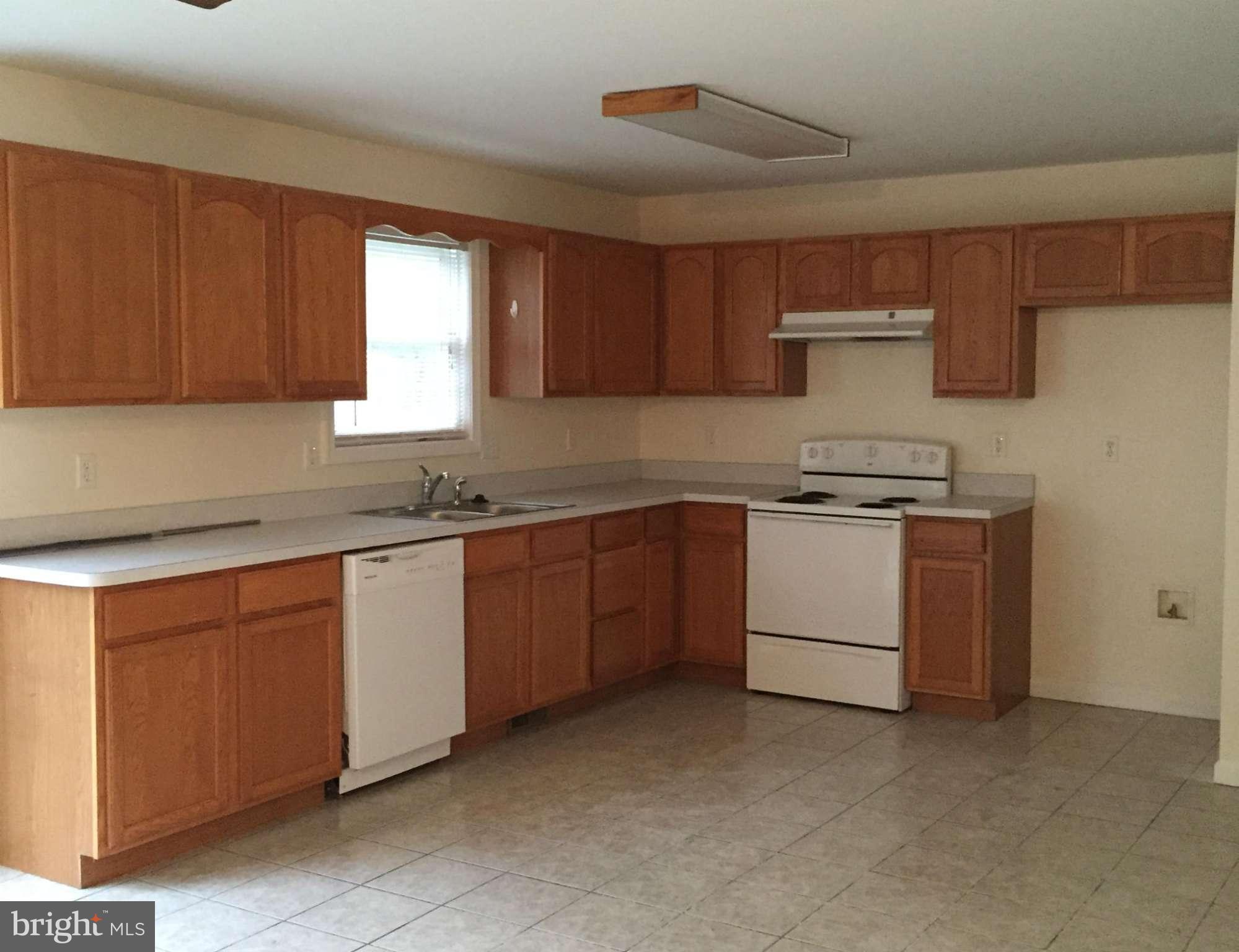 41 Gibson Road Inwood, WV 25428 - Photo 7 of 26 a kitchen with sink a stove and cabinets