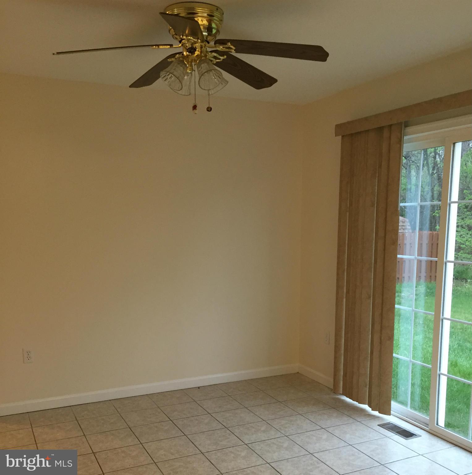 41 Gibson Road Inwood, WV 25428 - Photo 8 of 26 an empty room with a ceiling fan and a window
