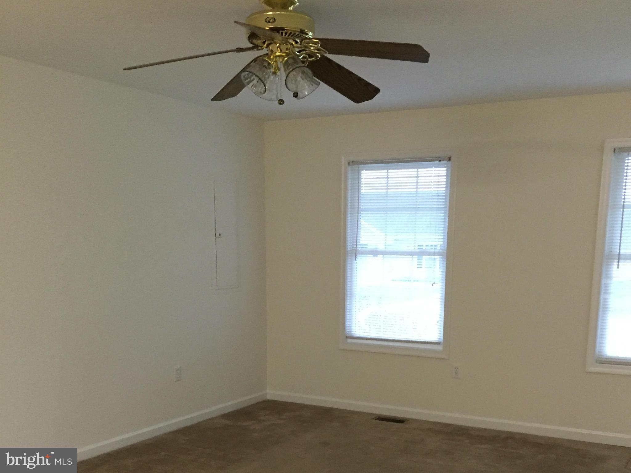 41 Gibson Road Inwood, WV 25428 - Photo 9 of 26 an empty room with a window and a fan