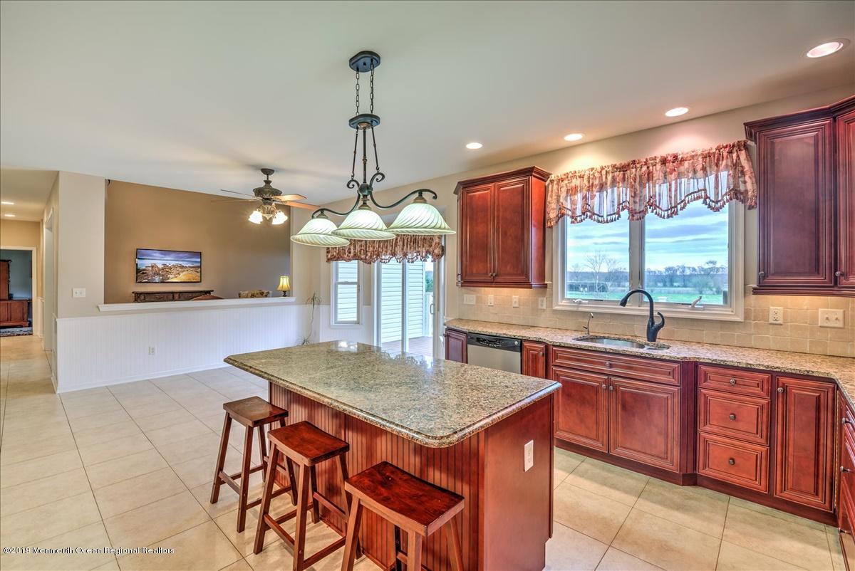 3 Yellow Meetinghouse Road Millstone Township, NJ 08510 - Photo 14 of 29 a kitchen with a stove a sink a counter space and a dining table with wooden floor