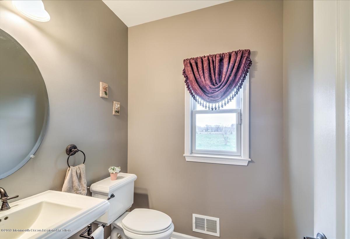 3 Yellow Meetinghouse Road Millstone Township, NJ 08510 - Photo 16 of 29 a bathroom with a toilet a sink and mirror