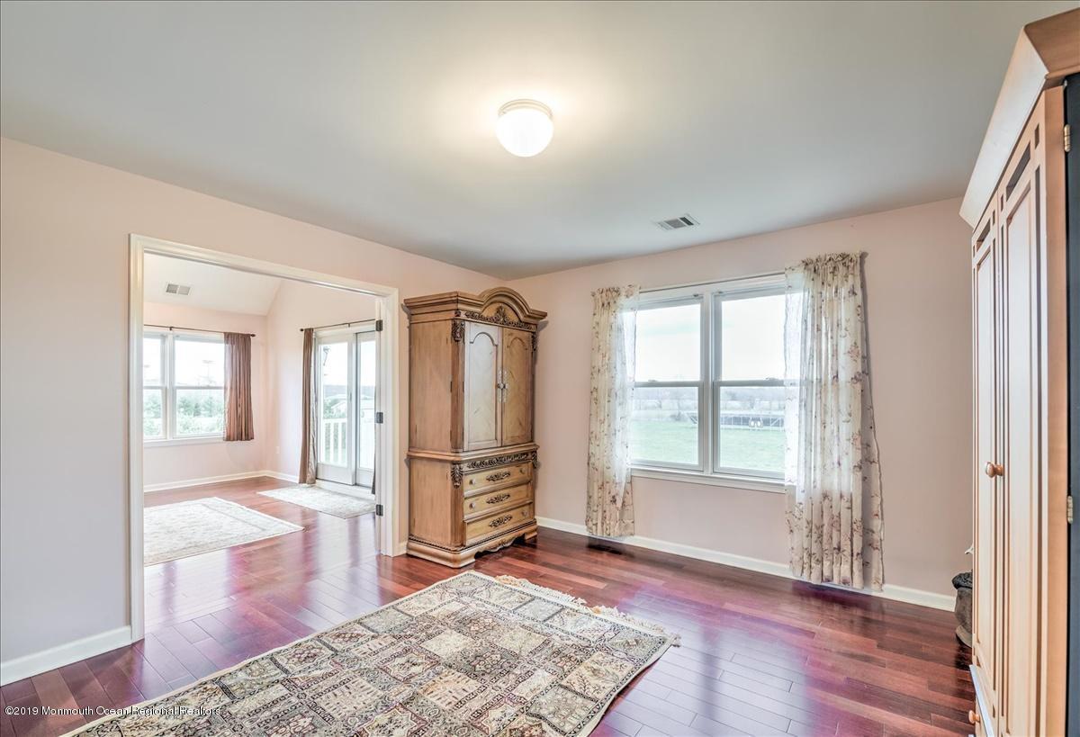 3 Yellow Meetinghouse Road Millstone Township, NJ 08510 - Photo 22 of 29 a view of a livingroom with wooden floor and a rug